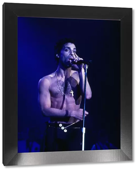 Singer Prince August 1986 on stage bare chested singing into microphone at Wembley