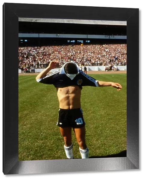 Diego Maradona pulling on Scotland top 1979