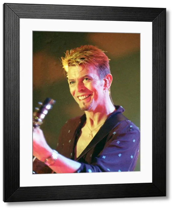 Framed Print : Singer David Bowie July 1997 Playing the guitar live on stage at the Glasgow Barrowlands