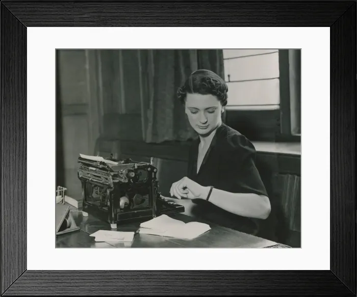 Framed Print : Female office worker checking her watch June 1937 Framed Print : Female office worker checking her watch June 1937