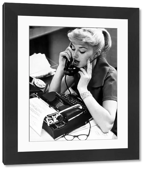 Office worker on the phone holding pencil, September 1958