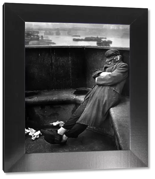Homeless tramp sleeping rough on Blackfriars Bridge, May 1943