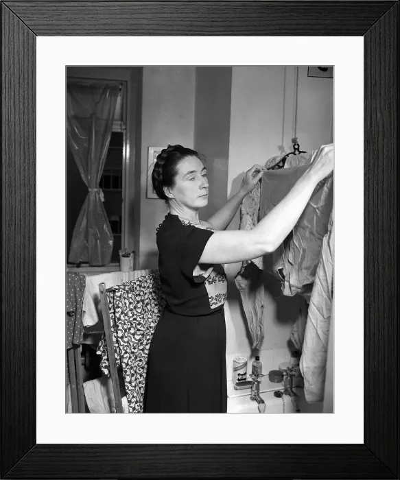 Framed Print : Housewives Washing Controversy Woman hanging up clothes to dry in her North Framed Print : Housewives Washing Controversy Woman hanging up clothes to dry in her North