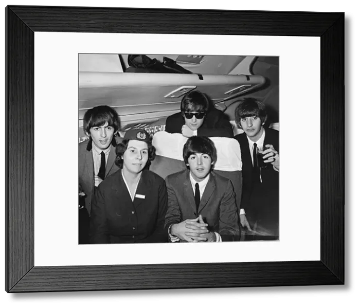Framed Print : The Beatles with an air hostess on a plane flying into Speke airport, Liverpool Framed Print : The Beatles with an air hostess on a plane flying into Speke airport, Liverpool