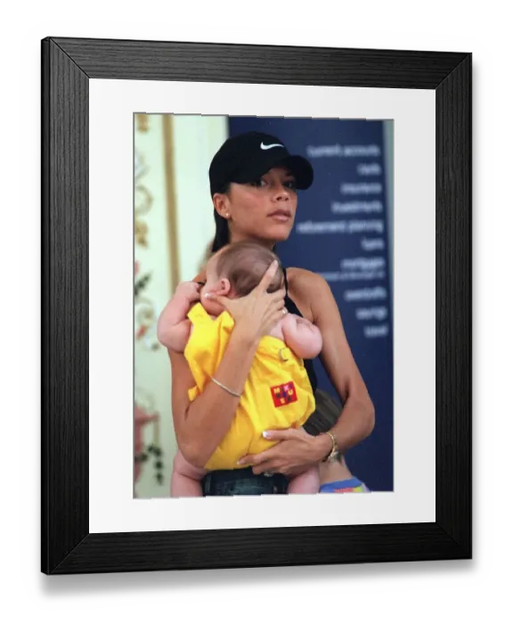 Framed Print : Victoria Adams ('Posh Spice') out shopping with baby Brooklyn in Trafford