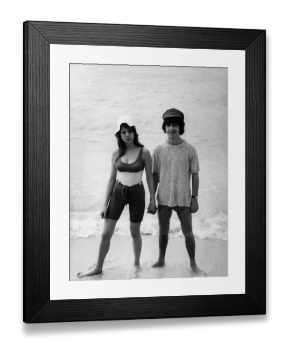 Framed Print : George Harrison of the Beatles with his new wife Patti Boyd on a beach February 1966 Framed Print : George Harrison of the Beatles with his new wife Patti Boyd on a beach February 1966