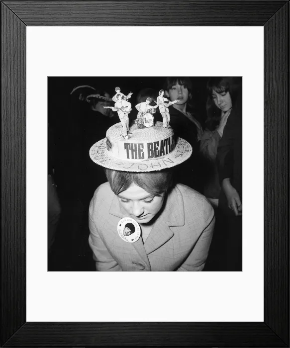Framed Print : A female fan of the Beatles pop group wearing a hat with a cut out of the Beatles on top Framed Print : A female fan of the Beatles pop group wearing a hat with a cut out of the Beatles on top