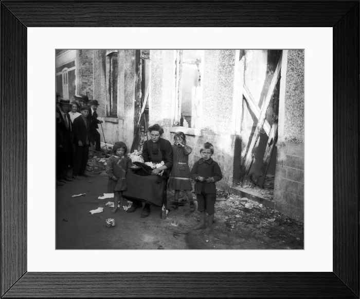 Framed Print : World War One. Widow and three children outside ruined home in Melle