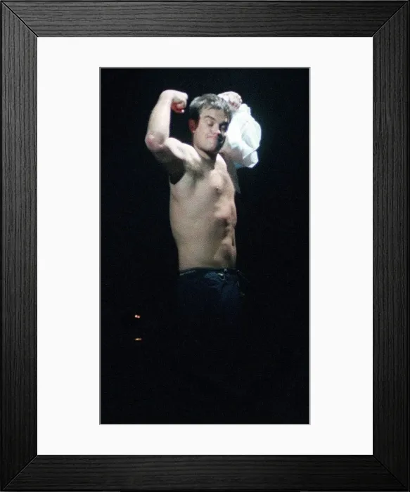 Framed Print : Robbie Williams in concert SECC Glasgow February 1999 takes of shirt shows off bare chest