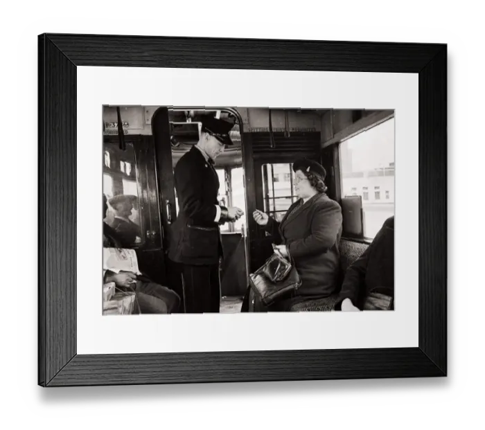 Framed Print : Bus Conductor collecting fares for passengers - circa 1948