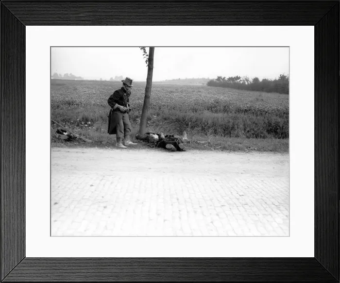 Framed Print : World War One. A wounded Belgian soldier falls by the roadside in 1914 Framed Print : World War One. A wounded Belgian soldier falls by the roadside in 1914