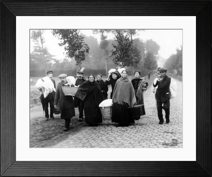 Framed Print : World War One - Refugees walk along the road carrying their possessions after fleeing