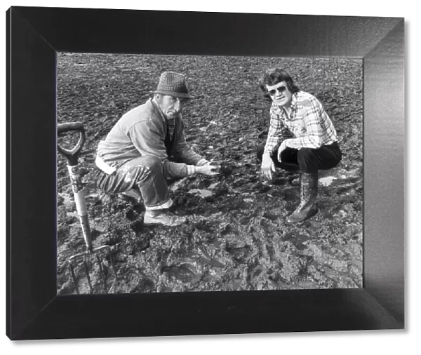 A concerned Eddie McCreadie (R) Chelsea Football Club manager examines the surface water