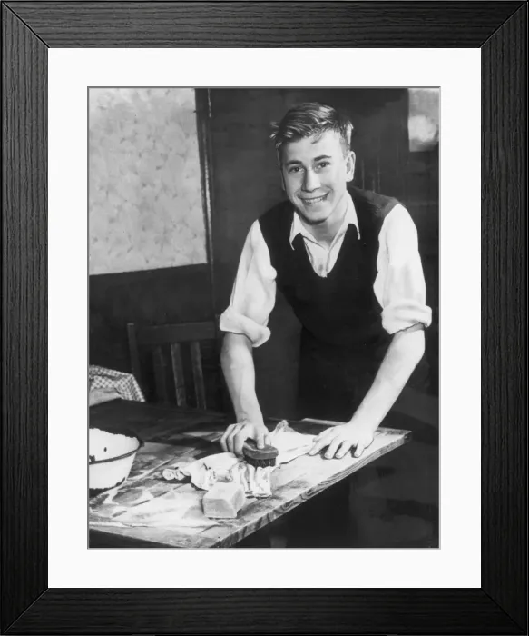Framed Print : Englands Bobby Charlton aged 15, helping his mother with the housework at home, 1953