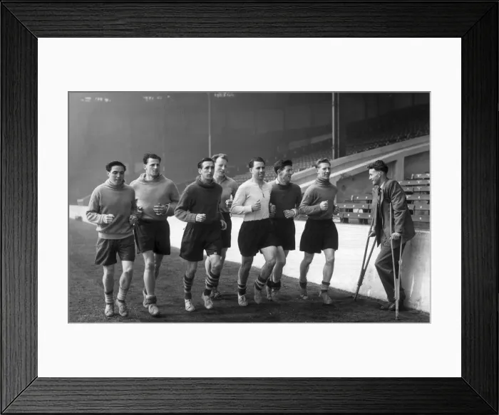 Framed Print : Manchester City football players pictured during training session as they jog around