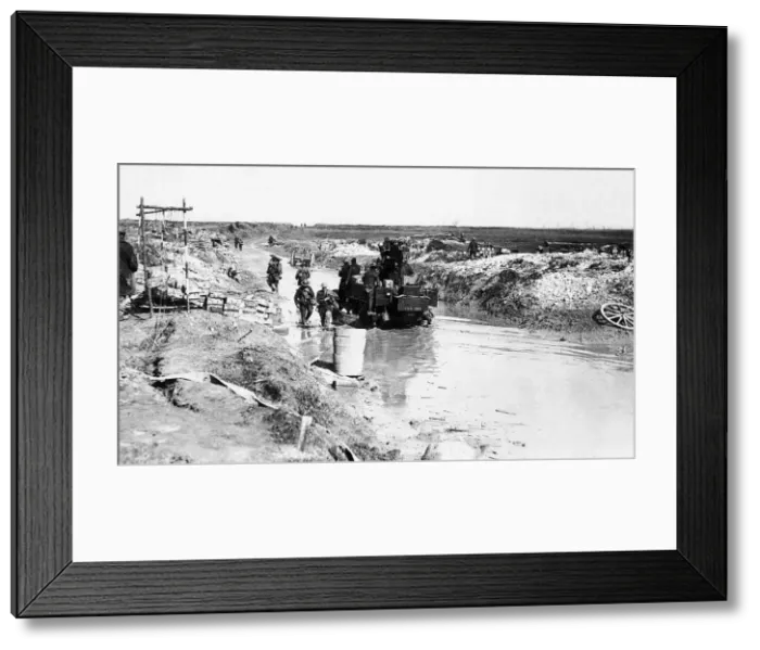 Framed Print : World War One mobile anti-aircraft gun is driven along a flooded road beside an Framed Print : World War One mobile anti-aircraft gun is driven along a flooded road beside an