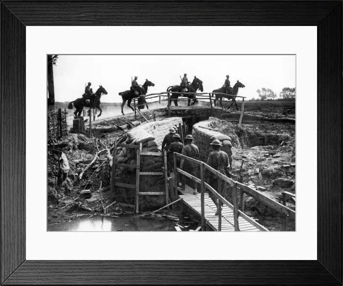 Framed Print : World War One Cavalry crossing a bridge thrown across a trench with troops going Framed Print : World War One Cavalry crossing a bridge thrown across a trench with troops going