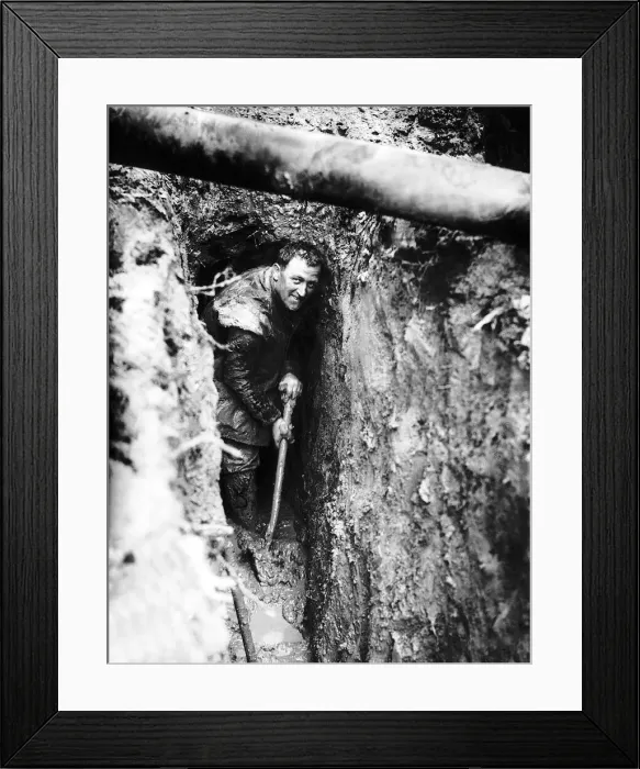 Framed Print : Royal Irish Fusilier Ferguson from Armagh clears mud from his trench in the forward lines Framed Print : Royal Irish Fusilier Ferguson from Armagh clears mud from his trench in the forward lines