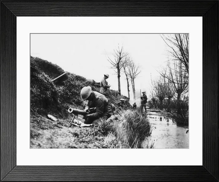 Framed Print : World War One- a British soldier repairs a machine gun in a trench on the British Framed Print : World War One- a British soldier repairs a machine gun in a trench on the British
