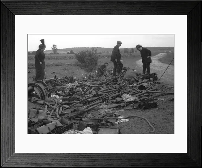 Framed Print : Civilians look at heap of rifles left in the field by the Germans during World War Framed Print : Civilians look at heap of rifles left in the field by the Germans during World War