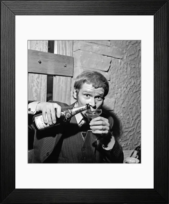 Framed Print : Singer Long John Baldry celebrates doing to the top of the charts with a bottle of Framed Print : Singer Long John Baldry celebrates doing to the top of the charts with a bottle of