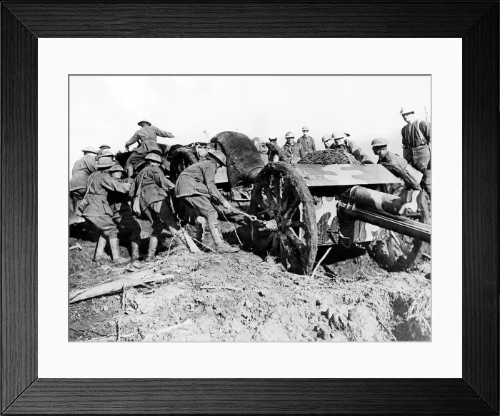Framed Print : Austraian soldiers drag their gun through the mud of a French field. December 1917