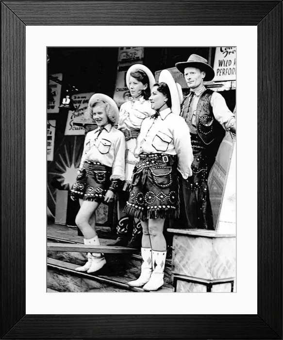 : The Wild West Show is about to get underway and the performers are trying to attract : The Wild West Show is about to get underway and the performers are trying to attract