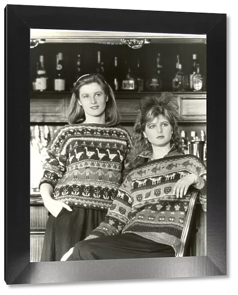 Women wearing matching knitted jumpers