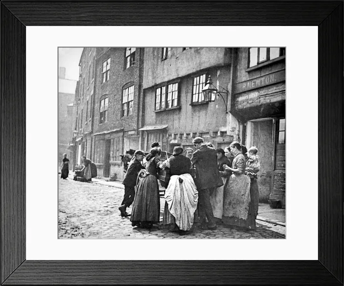 Framed Print : A scene of working class life - women gather round the horse-drawn cart of a street Framed Print : A scene of working class life - women gather round the horse-drawn cart of a street