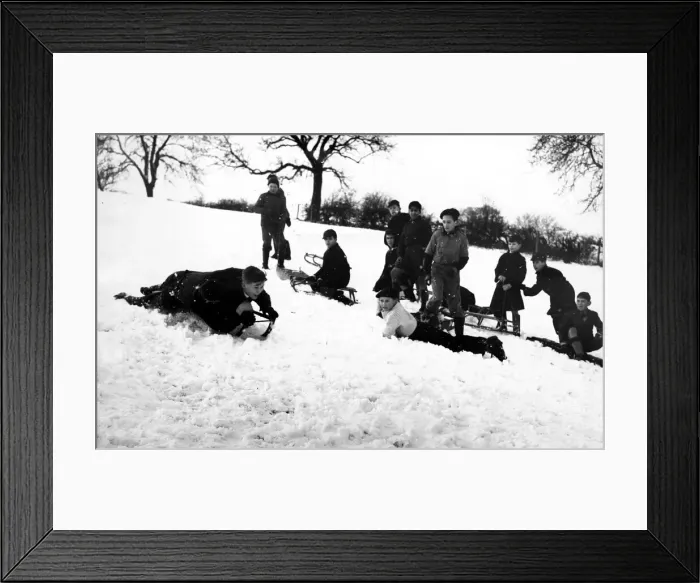 Framed Print : Its all about who can go the fastest as children go sledging in 1960 Framed Print : Its all about who can go the fastest as children go sledging in 1960