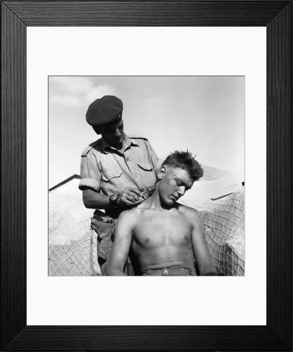 Framed Print : Suez Crisis 1956 Brigade Sergeant Major Ernest Lambert cuts the hair of Gunner Jim