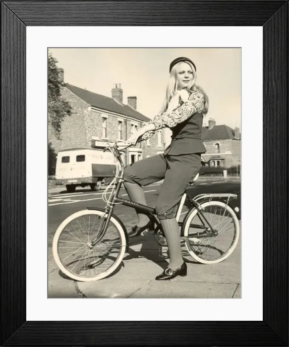 Framed Print : A girl wearing pedal pushers on bicycle Framed Print : A girl wearing pedal pushers on bicycle