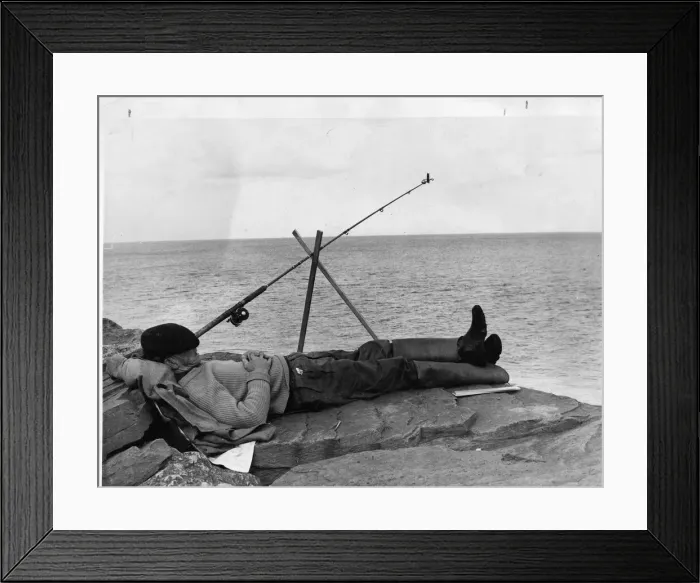 Framed Print : Man having forty winks while fishing. 24th June 1965