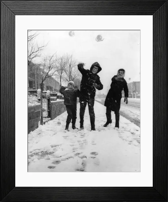 Framed Print : Three youngsters at Llanrumney, Cardiff throw snowballs at the cameraman during Framed Print : Three youngsters at Llanrumney, Cardiff throw snowballs at the cameraman during