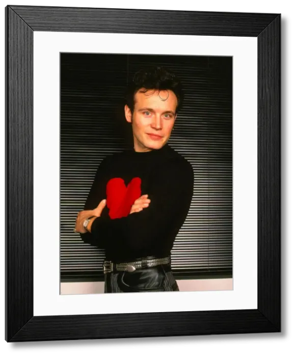 Framed Print : Adam Ant pop singer January 1990 Arms folded black jumper red heart - Stuart