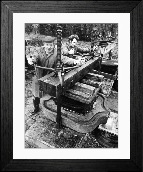 : Mr Frank Harris and his son John, working the cider press at Church Lench. December 1974 : Mr Frank Harris and his son John, working the cider press at Church Lench. December 1974