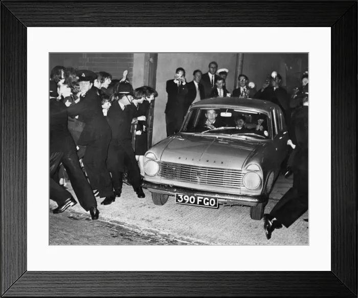Framed Print : The Beatles in a Hillman with fans held back by the police at the Birmingham Hippodrome