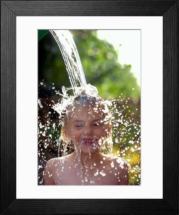 Framed Print : Sophie Davies (6yrs) (daughter of photographer) cools off in the hot weather with a Framed Print : Sophie Davies (6yrs) (daughter of photographer) cools off in the hot weather with a