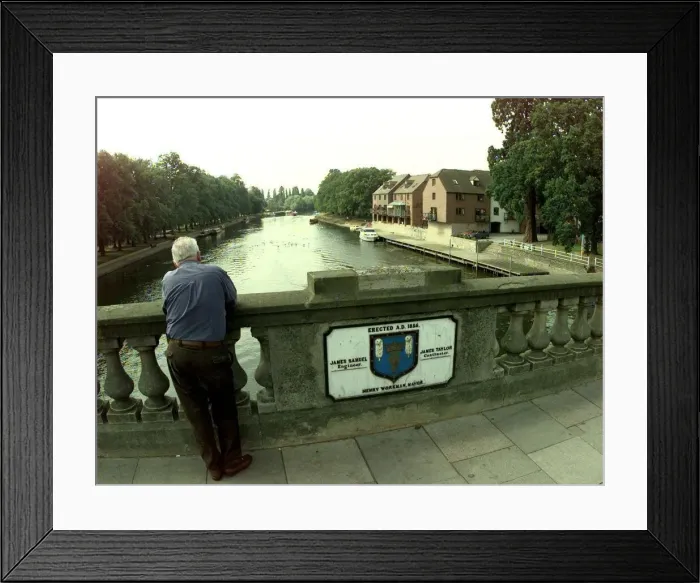 Framed Print : A view from the Workman Bridge in Evesham. Man standing on a bridge over the River Avon
