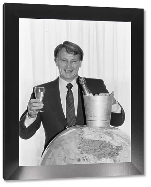 England manager Bobby Robson holds a glass of champagne in one hand looks forward to