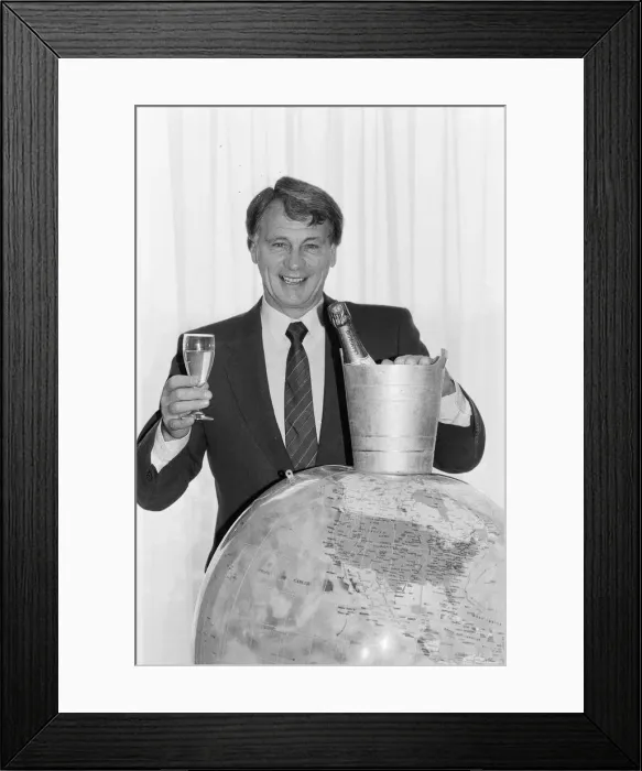 Framed Print : England manager Bobby Robson holds a glass of champagne in one hand looks forward to Framed Print : England manager Bobby Robson holds a glass of champagne in one hand looks forward to