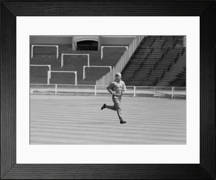 Framed Print : Manchester United footballer Bobby Charlton warms up at an empty Wembley Stadium prior to