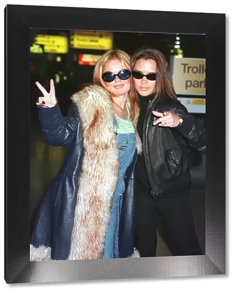 Spice Girls Geri Halliwell (L) and Victoria Adams (R) leaving Heathrow for Toronto