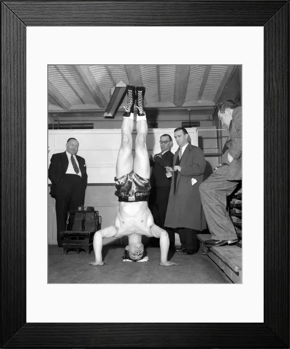Framed Print : Cruiser weight boxer George walker doing a head stand at the weigh in November 1957