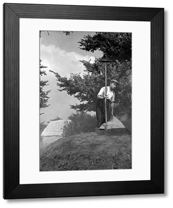 Framed Print : A farmer standing on top of a mound of peat circa 1938 Framed Print : A farmer standing on top of a mound of peat circa 1938