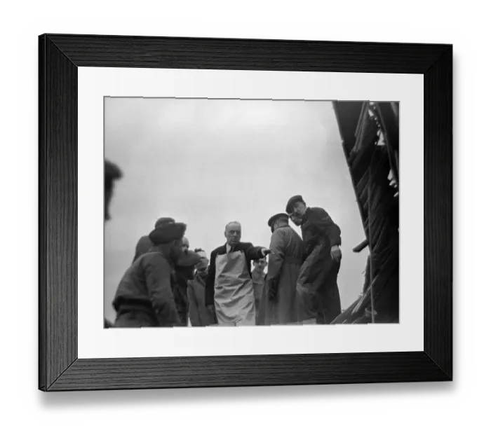 Framed Print : A doctor directs rescue workers following overnight air raids on London February Framed Print : A doctor directs rescue workers following overnight air raids on London February