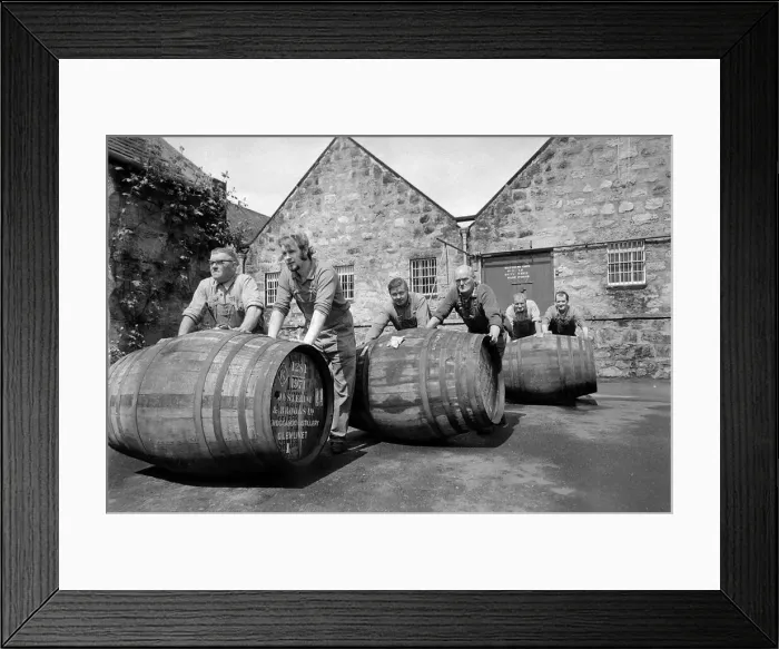 Framed Print : Workers rolling barrels of Whisky to the bonded warehouse at the Knockando Whisky Framed Print : Workers rolling barrels of Whisky to the bonded warehouse at the Knockando Whisky