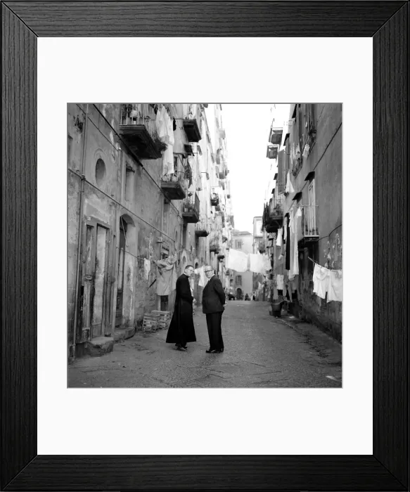 Framed Print : A priest chats to a elderly man in a street in the old town quarter of Naples in Southern