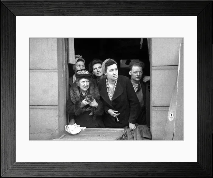 Framed Print : A man and four women with a kitten look out a window at the bomb damage in Kentish Town Framed Print : A man and four women with a kitten look out a window at the bomb damage in Kentish Town