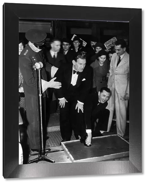 Actor Will Hay has his feet set in concrete on arrival for a personnal appearence at